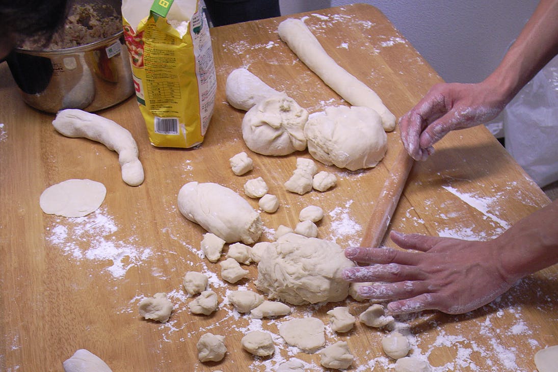 a person making pasta on a table